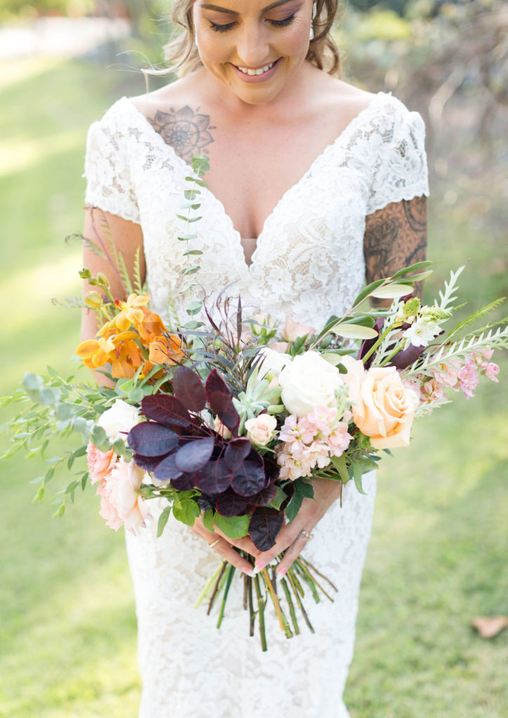 Bridal bouquet with fall foliage white roses and peach roses