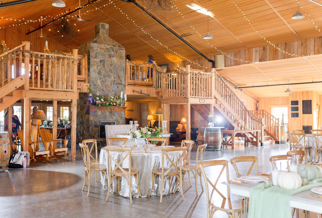 Barn wedding with x back chairs. Velvet Linens. Mixed seating